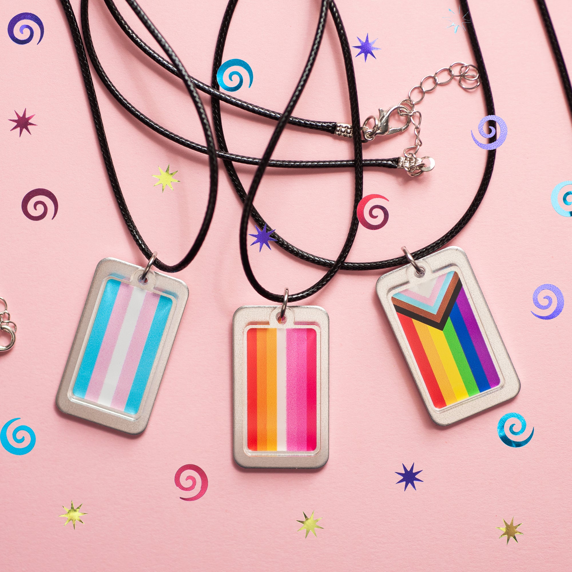 3 pride flag necklaces displayed on a fun background